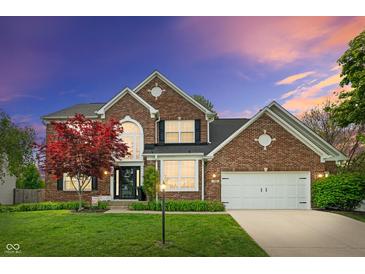 Charming two-story brick home with a well-manicured lawn and attached two car garage at 828 Breaside Ln, Greenwood, IN 46143