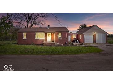 Charming single-story brick home featuring a detached garage and inviting front porch at 10473 N County Road 950 E, Brownsburg, IN 46112