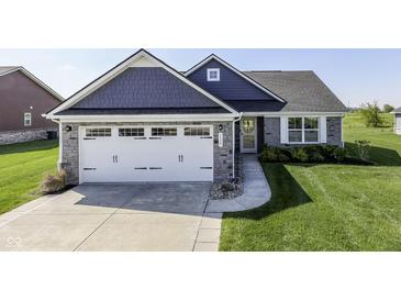 Beautiful home with a stone and shingle exterior, well-manicured lawn, and a two-car garage at 1115 Senate Dr, Edinburgh, IN 46124