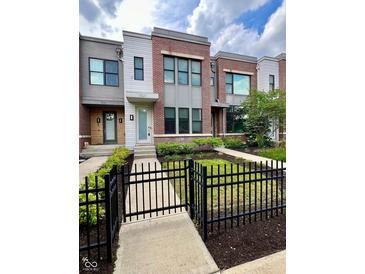 Beautiful townhouse with a manicured lawn and modern architectural details, creating a welcoming curb appeal at 1520 Central Ave, Indianapolis, IN 46202
