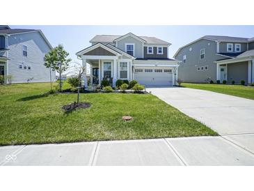 Charming two-story home with a manicured lawn and attached two-car garage at 15413 Staffordshire Way, Fishers, IN 46037