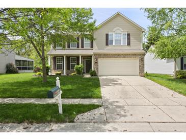 Charming two-story home with a well-manicured front yard and an attached two-car garage at 16001 Concert Way, Noblesville, IN 46060