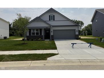 Charming single-Gathering home with a manicured lawn and attached two car garage at 2143 Warbler St, Danville, IN 46122