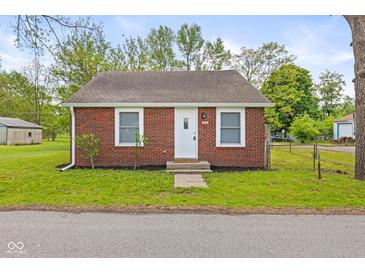 Charming brick home with a well-manicured lawn and a classic white front door at 2321 W 26Th St, Anderson, IN 46016