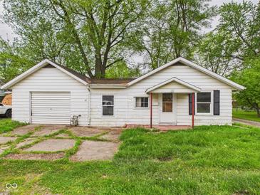 Charming single-story home with attached garage and covered entry on a lush lawn at 29 E Pine St, Anderson, IN 46012