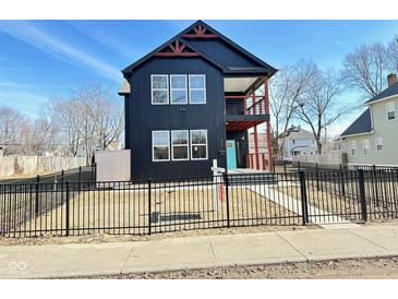 Modern two-story home with black siding, white trim, and a welcoming blue front door at 337 N Beville Ave, Indianapolis, IN 46201