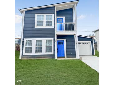 Charming two-story home with blue front doors, white trim, and an attached garage, and manicured lawn at 3811 N Lawndale Ave, Indianapolis, IN 46254