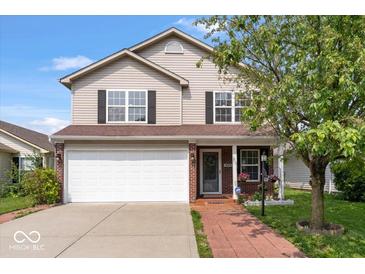 Charming two-story home featuring a two-car garage and a welcoming brick-lined walkway leading to the front door at 4316 Village Trace Dr, Indianapolis, IN 46254