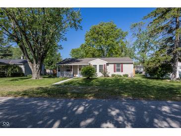 Charming single-story home with a well-manicured lawn and mature trees on a sunny day at 540 Hanley St, Plainfield, IN 46168
