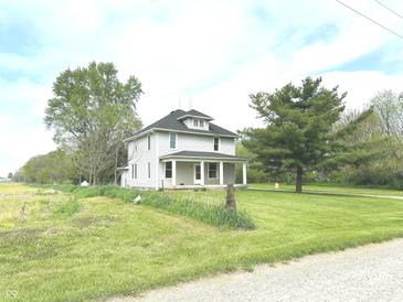 Charming two-story home with a covered front porch and mature trees in the yard at 660 N 700 E, Whitestown, IN 46075