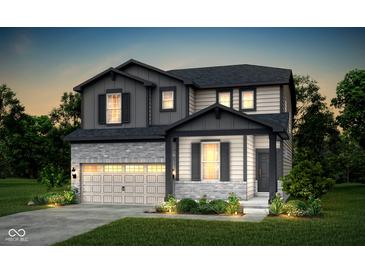 Charming two-story home with brick and siding, a two-car garage, and a beautifully landscaped front yard at 778 Adler Dr, Avon, IN 46123