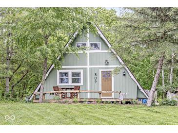 Charming A-frame home featuring a cozy front deck and lush greenery, perfect for outdoor relaxation at 809 Iron Bridge Rd, Cicero, IN 46034