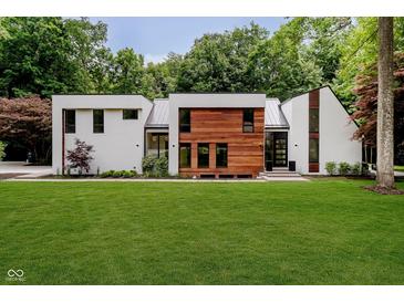 Modern two-story home featuring a beautifully landscaped lawn and mixed material exterior at 11911 Eden Glen Dr, Carmel, IN 46033