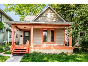 Charming home featuring a covered porch with orange columns and freshly painted trim accents at 2114 Sugar Grove Ave, Indianapolis, IN 46202