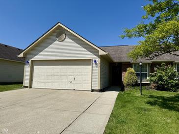 Charming single-story home with a well-maintained lawn and attached two-car garage at 212 Woodberry Dr, Danville, IN 46122