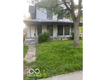 Two story home with covered porch and lawn at , Indianapolis, IN 46205
