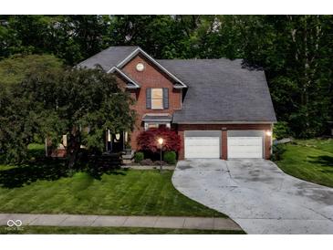 Two-story brick home with an attached garage and a landscaped yard at 310 Wellington Overlook, Noblesville, IN 46060