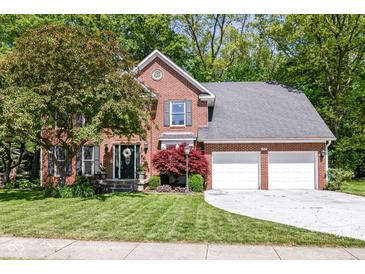 Charming brick two-story home with attached two-car garage and a well-manicured front lawn at 310 Wellington Overlook, Noblesville, IN 46060