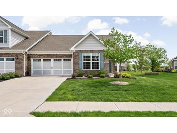 Charming brick home featuring a two-car garage, blue shutters, and a well-maintained lawn with landscaping at 4034 Cairo Way, Avon, IN 46123