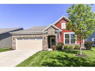 Charming single-story home with brick and red siding, an attached garage, and manicured lawn on a sunny day at 4039 Amaryllis Dr, Plainfield, IN 46168