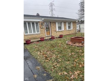 Charming brick home with a well-manicured lawn and inviting entryway at 6209 Meadowlark Dr, Indianapolis, IN 46226