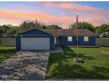 Charming single-story home with a well-manicured lawn and attached garage at 7645 Madden Dr, Fishers, IN 46038