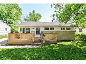 Charming home featuring a cozy front deck, stone accents, and a well-maintained lawn at 7849 E 49Th St, Indianapolis, IN 46226