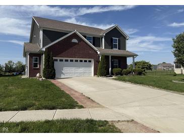 Two-story home with brick and siding, featuring an attached two-car garage and well-maintained front lawn at 928 Cherry Tree Ln, Greenwood, IN 46143