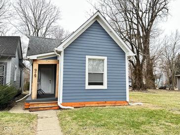Charming single-Gathering home featuring light blue siding, crisp white trim, and a well-maintained lawn at 929 W Roache St, Indianapolis, IN 46208