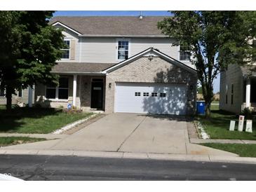 Two-story home featuring brick accents, a two-car garage, and a well-maintained lawn at 10773 Brighton Knoll S Pkwy, Noblesville, IN 46060