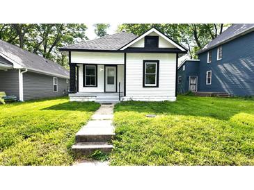 Charming bungalow with black and white trim, featuring a small front porch and walkway to the home at 1148 N Pershing Ave, Indianapolis, IN 46222