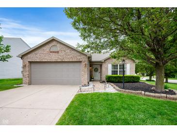 Charming brick home with a well-manicured lawn and beautiful landscaping at 12446 Deerview Dr, Noblesville, IN 46060