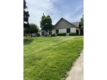 Well-manicured lawn and landscaped yard enhance this charming home's curb appeal at , Shelbyville, IN 46176