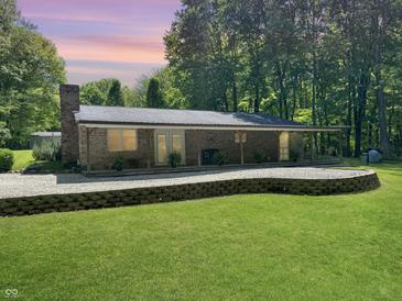 Ranch style home featuring a brick exterior, covered porch, and meticulously manicured lawn at 2548 N Letterman Rd, Paragon, IN 46166