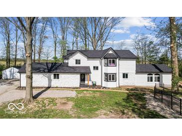 Charming two-story home featuring a well-manicured lawn and inviting curb appeal at 3868 E Worthsville Rd, Whiteland, IN 46184