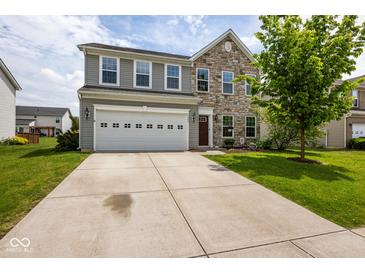 Charming two-story home featuring stone accents, a two-car garage, and a well-manicured front yard at 6683 School Branch Dr, Brownsburg, IN 46112