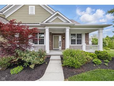 Charming brick home featuring a covered front porch with classic white columns and inviting curb appeal at 902 Racetime Rd, Westfield, IN 46074