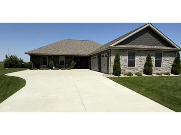 Charming single-story home featuring a stone facade, well-manicured lawn, and spacious driveway at 920 Alba Dr, Lebanon, IN 46052