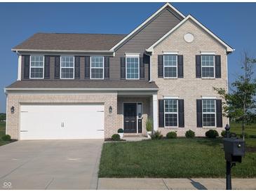 Charming two-story brick home with a two-car garage and well-manicured lawn in a suburban neighborhood at 9860 Gallop Ln, Fishers, IN 46040