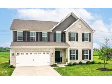 Charming two-story home featuring a brick facade, black shutters, attached garage, and well-manicured front lawn at 9860 Gallop Ln, Fishers, IN 46040