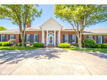 Beautiful brick home with manicured landscaping and a charming front porch, perfect for relaxing at 1105 Deer Creek Dr, Anderson, IN 46011