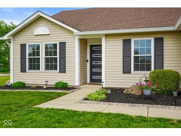 Close-up view of the front door and exterior of the home, highlighting the landscaping at 204 Oakview Dr, Mooresville, IN 46158