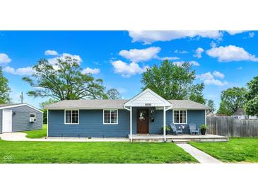 Charming blue house with a welcoming front porch, perfect for relaxing outdoors and enjoying neighborhood views at 2303 Midway St, Columbus, IN 47201