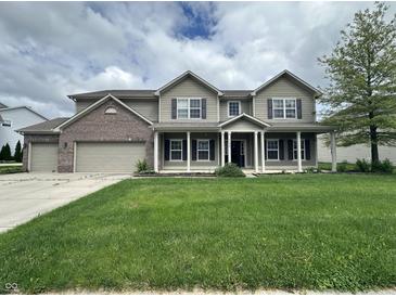 Charming two-story home featuring a welcoming front porch and three-car garage at 2680 Newington Ln, Carmel, IN 46074