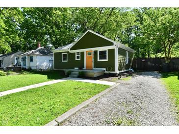 Charming one-story home with a green exterior, orange door, and well-maintained lawn at 3021 Eastern Ave, Indianapolis, IN 46218