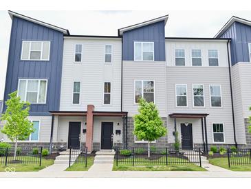 Attractive townhomes with blue and gray siding, black doors, and well-manicured landscaping at 3110 W New York St, Indianapolis, IN 46222