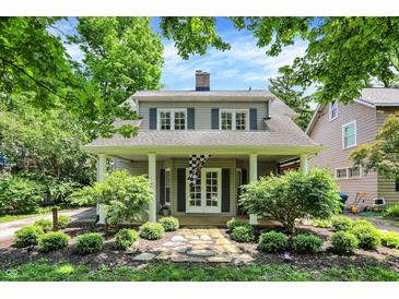 Charming two-story home with a covered front porch, manicured landscaping, and inviting curb appeal at 4527 Central Ave, Indianapolis, IN 46205