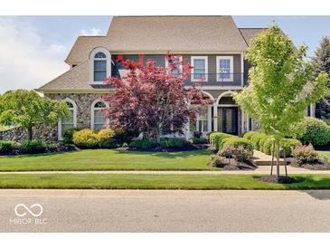 Charming two-story home with landscaped yard and stone accents, presenting excellent curb appeal at 6648 Westminster Dr, Zionsville, IN 46077