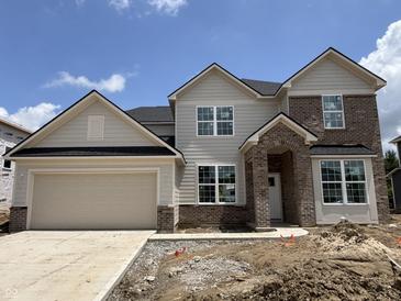 Charming two-story home with attached two car garage featuring neutral siding and brick accents at 7239 Barrett Dr, Brownsburg, IN 46112