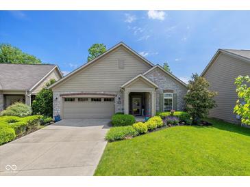 Charming single-story home boasts a well-manicured lawn and a welcoming front porch at 9789 Rue Renee Ln, McCordsville, IN 46055